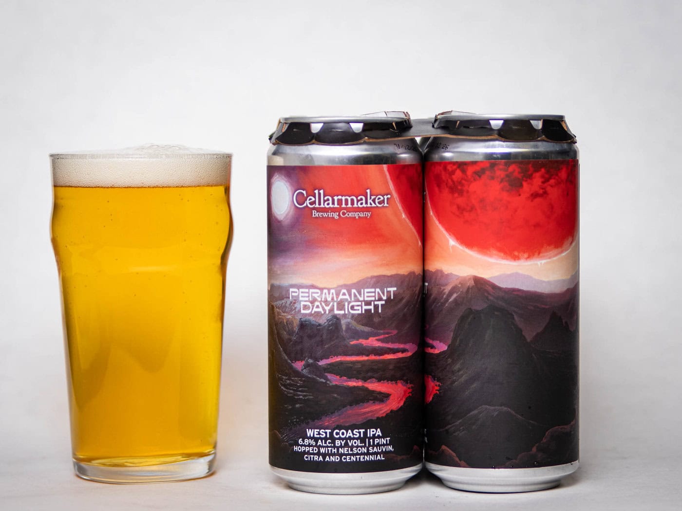 A Pint Glass Of Pale Golden Beer Sits Next To Two Cans Labeled &Amp;Quot;Permanent Daylight&Amp;Quot; From Cellarmaker Brewing Company, Featuring A Red And Black Landscape With A Bright Sky On The Can Art.
